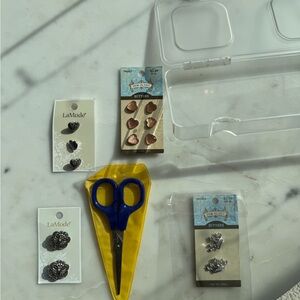 Assorted Button and Scissors Set. Plastic storage box includes